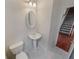 Clean half bathroom with pedestal sink and staircase visible at 1156 Madison Green Sw Ln, Mableton, GA 30126