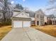 Charming two-story home boasts a two-car garage and manicured front lawn at 1156 Madison Green Sw Ln, Mableton, GA 30126