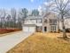 Charming two-story home boasts a two-car garage and manicured front lawn at 1156 Madison Green Sw Ln, Mableton, GA 30126