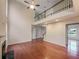 Spacious living room with hardwood floors, soaring ceilings, a fireplace, and staircase leading to a second floor loft at 1156 Madison Green Sw Ln, Mableton, GA 30126