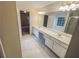 Bright main bathroom with a double vanity, large mirror, and luxurious finishes at 1156 Madison Green Sw Ln, Mableton, GA 30126