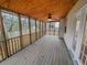 The porch has a wooden deck, screen walls, and a ceiling fan at 1156 Madison Green Sw Ln, Mableton, GA 30126