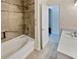 Accessible bathroom with a tiled shower-tub combo, grab bars, and a neutral color scheme at 1485 Riverrock Trl, Riverdale, GA 30296
