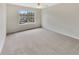 Bright bedroom with neutral carpet, a large window providing natural light, and spacious layout at 1485 Riverrock Trl, Riverdale, GA 30296