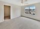 Bright bedroom featuring plush carpeting, a ceiling fan and a window with neighborhood views at 1485 Riverrock Trl, Riverdale, GA 30296