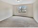 Comfortable bedroom with neutral carpet and a large window with great backyard views at 1485 Riverrock Trl, Riverdale, GA 30296