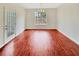 The dining room has hardwood flooring and a large window that allows natural light to illuminate the space at 1485 Riverrock Trl, Riverdale, GA 30296