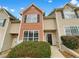 Inviting townhouse with a mix of brick and vinyl siding, featuring large windows and well-maintained landscaping at 1485 Riverrock Trl, Riverdale, GA 30296