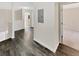 Upstairs hallway with wood-look flooring leading to bedrooms and bathrooms at 1485 Riverrock Trl, Riverdale, GA 30296