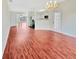 Open-concept floor plan showcasing wood-look flooring that connects the living and kitchen areas at 1485 Riverrock Trl, Riverdale, GA 30296