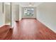 Spacious living room with rich flooring, offering ample natural light and a versatile space for decorating at 1485 Riverrock Trl, Riverdale, GA 30296