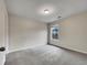 Neutral bedroom with carpet flooring and a window overlooking a green outdoor space at 163 Denver Ave, Hiram, GA 30141