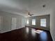 Bright living room showcasing hardwood floors, a ceiling fan, and natural light from multiple windows at 1970 Old Dogwood, Jonesboro, GA 30238