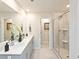 Bright bathroom featuring double vanity, shower, and neutral tile flooring at 363 Denali Butte Ter, Canton, GA 30114