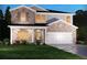 Charming two-story brick home with an attached two-car garage and a well-manicured lawn at 363 Denali Butte Ter, Canton, GA 30114