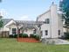 Spacious backyard featuring a pergola-covered area, a well-manicured lawn, privacy fencing, and mature landscaping at 4565 Bridle Point Pkwy, Snellville, GA 30039