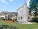 Backyard featuring grass, bushes, stone patio, and pergola at 4565 Bridle Point Pkwy, Snellville, GA 30039
