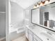 Bright bathroom featuring double sink vanity, tub, and separate shower at 4565 Bridle Point Pkwy, Snellville, GA 30039