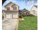 Charming two-story home with a two-car garage and well-maintained landscaping, red shutters, and symmetrical curb appeal at 4565 Bridle Point Pkwy, Snellville, GA 30039