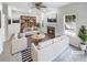 Bright, virtually staged living room with modern furnishings, fireplace, a ceiling fan, and large windows for natural light at 4565 Bridle Point Pkwy, Snellville, GA 30039