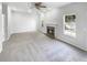Spacious living room featuring a fireplace, neutral carpet, recessed lighting, a ceiling fan, and bright windows at 4565 Bridle Point Pkwy, Snellville, GA 30039