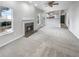 Open-concept living room with fireplace, carpet, and view of the kitchen, creating a cozy and inviting atmosphere at 4565 Bridle Point Pkwy, Snellville, GA 30039