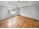 Spacious main bedroom features hardwood floors, ceiling fan, and tray ceiling at 4565 Bridle Point Pkwy, Snellville, GA 30039