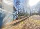 Backyard featuring mature trees creating a tranquil outdoor space at 5407 Effingham Ct, Lithonia, GA 30038