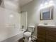 Clean bathroom featuring a shower-tub combo, new wooden vanity, and modern fixtures at 5407 Effingham Ct, Lithonia, GA 30038