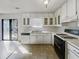 Well-lit kitchen featuring white cabinets, granite countertops, and modern appliances at 5407 Effingham Ct, Lithonia, GA 30038