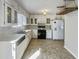 Bright kitchen featuring white cabinets, modern appliances, and tile flooring at 5407 Effingham Ct, Lithonia, GA 30038