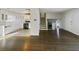 Inviting open-concept living room with hardwood floors leading into the kitchen with white cabinets and stainless steel appliances at 5407 Effingham Ct, Lithonia, GA 30038