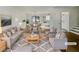 Bright and airy living room featuring modern decor, hardwood floors, and seamless transition to the dining area at 5407 Effingham Ct, Lithonia, GA 30038
