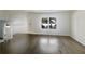 Bright living room with hardwood floors, a staircase, and a large window offering abundant natural light at 5407 Effingham Ct, Lithonia, GA 30038