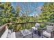 Wooden deck with outdoor furniture surrounded by lush trees at 1235 King Springs Se Ct, Smyrna, GA 30080