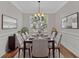Elegant dining room featuring hardwood floors, decorative wainscoting, and a stylish chandelier at 1235 King Springs Se Ct, Smyrna, GA 30080