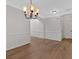 Formal dining room with classic chandelier, wainscoting, and hardwood floors at 1235 King Springs Se Ct, Smyrna, GA 30080