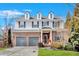 Charming two-story home featuring a brick and siding facade, dormer windows, and a well-manicured front lawn at 1235 King Springs Se Ct, Smyrna, GA 30080