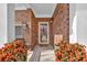 Inviting front porch with brick walls, decorative potted plants, and a welcoming entrance at 1235 King Springs Se Ct, Smyrna, GA 30080