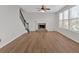 Open living room with large window views and a stone fireplace at 1235 King Springs Se Ct, Smyrna, GA 30080