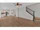 Open-concept living room with hardwood floors that flows into a kitchen with white cabinetry and stainless-steel appliances at 1235 King Springs Se Ct, Smyrna, GA 30080