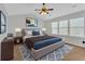 This main bedroom features a large bed, ceiling fan, and ample natural light from the windows at 1235 King Springs Se Ct, Smyrna, GA 30080