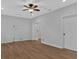 This bonus room features light gray walls, hardwood floors, ceiling fan, and two doors at 1235 King Springs Se Ct, Smyrna, GA 30080