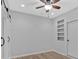 Bonus room with light gray walls, ceiling fan, and a sliding barn door at 1235 King Springs Se Ct, Smyrna, GA 30080