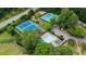 Aerial view of community amenities including pool, tennis courts, parking, and clubhouse surrounded by trees at 203 Northside Nw Dr, Kennesaw, GA 30144