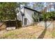 A quaint backyard with a wooden fence, grass yard, and a cozy swing, ideal for relaxation and play at 203 Northside Nw Dr, Kennesaw, GA 30144