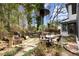 A home's outdoor living space features patio, dining table, built-in grill, and tranquil pond at 203 Northside Nw Dr, Kennesaw, GA 30144