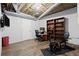 Finished basement area with a desk, TV and an exercise machine at 203 Northside Nw Dr, Kennesaw, GA 30144