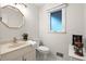 Elegant powder room featuring a modern vanity with decorative mirror, a window and stylish fixtures at 203 Northside Nw Dr, Kennesaw, GA 30144