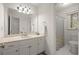 Bright bathroom with a large mirror, double sink vanity, and shower with patterned curtain at 203 Northside Nw Dr, Kennesaw, GA 30144